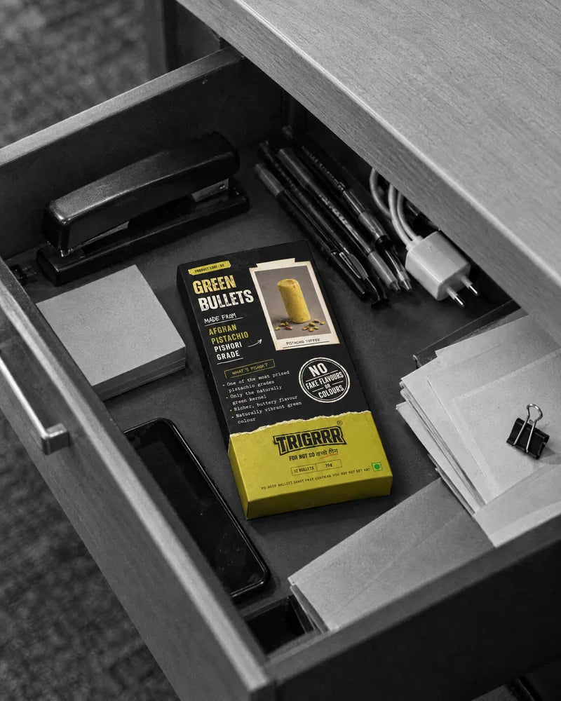 A Green Bullets box in an open office desk drawer