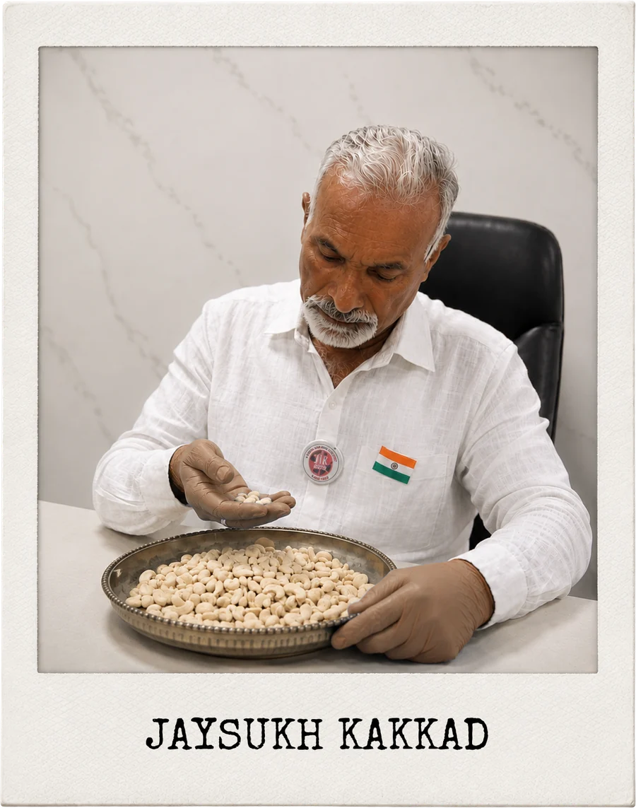 Jaysukh Kakkad sorting nuts in a steel tray